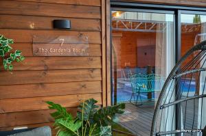 a sign on the side of a wooden wall at Novus Luxury in Yarka