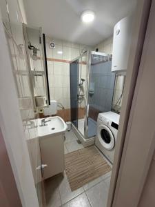a bathroom with a sink and a washing machine at Apartments La Natalli in Baška +76 photos