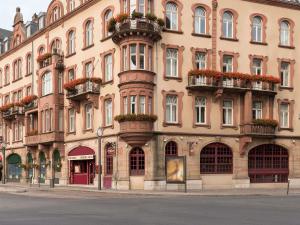 a large building with flower boxes on the side of it at ibis Metz Centre Gare in Metz