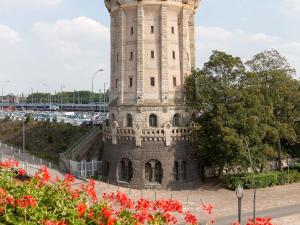 a white tower with red flowers in front of it at ibis Metz Centre Gare in Metz +55 photos
