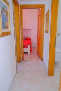 a hallway with a red bed in a room at La Casa di Barbara in Ponza