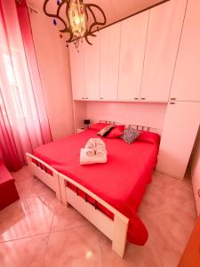 a bedroom with a red bed with a red blanket at La Casa di Barbara in Ponza