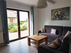 a living room with a couch and a table at Apartamenty bez barier in Rydzewo