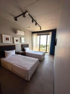 a hotel room with two beds and a window at Atlasia Suit in Erdemli +62 photos