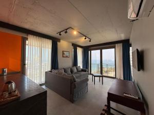 a living room with a couch and a table at Atlasia Suit in Erdemli