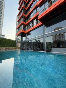 a large swimming pool in front of a building at Atlasia Suit in Erdemli