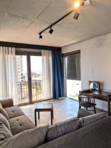 a living room with a couch and a table at Atlasia Suit in Erdemli