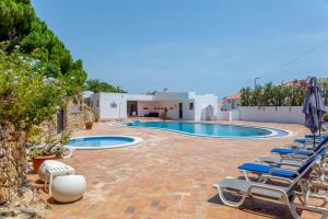 a swimming pool with lounge chairs and a resort at Albufeira Oasis Pool & Views in Albufeira