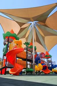 a childrens playground with a colorful play park at Sveltos Hotel in Larnaca