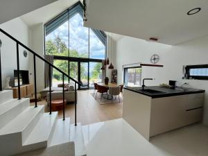 a kitchen and living room with a large window at Casa Verta in Skrad