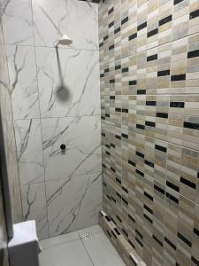 a bathroom with a shower with marble tiles at Casa Maceió The perfect place in Maceió +13 photos