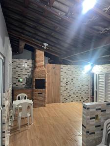 a room with a table and chairs and a brick wall at Casa Maceió The perfect place in Maceió