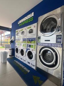 a laundry room with two washing machines in a store at Casa Maceió The perfect place in Maceió