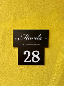 a sign on a wall with the number at Màrila in Aggius