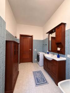 a bathroom with a sink and a washing machine at Màrila in Aggius