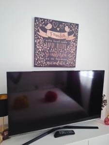 a flat screen tv sitting on top of a desk at Casa La Bunicu - Curte privata & liniste in Techirghiol