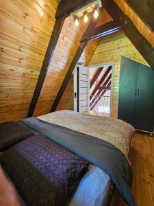 a bedroom with a bed in a wooden cabin at Ismayilli in İsmayıllı +18 photos