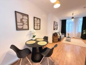 a living room with a table and chairs at Stage One City in Andernach