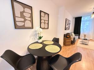 a living room with a black table and chairs at Stage One City in Andernach +12 photos