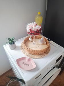 a table with a cake on top of a appliance at Casa La Bunicu - Curte privata & liniste in Techirghiol