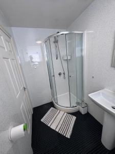 a bathroom with a shower and a sink at Mallow View Hotel in Cleethorpes