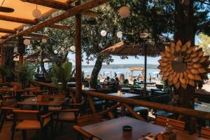 a restaurant with tables and chairs and a view of the beach at Boutique Hotel Solterra - Crikvenica in Crikvenica