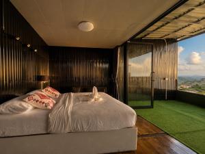 a bedroom with a bed and a large window at Holiday view ภูทับเบิก in Ban Maeo Thap Boek +26 photos