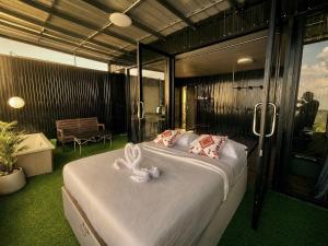 a bedroom with a bed with a white bunny on it at Holiday view ภูทับเบิก in Ban Maeo Thap Boek