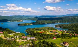 an aerial view of a town on the shore of a lake at Apartament nad Soliną in Polańczyk