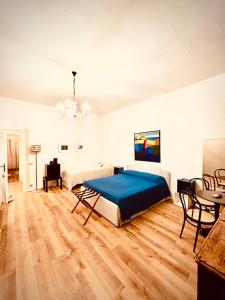 a bedroom with a bed and a table and chairs at Villa Bignago B&B in Arquà Petrarca