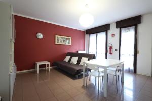 a living room with a couch and a table at Alby's apartment, nella Motor Valley con parcheggio privato in Formigine +30 photos