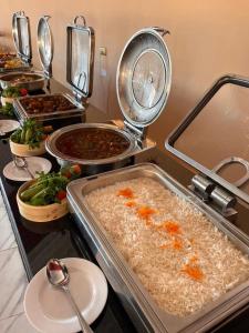 a kitchen with several pans of food on a counter at Wadi Rum Bella Rose Luxury Camp in Disah