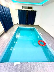 a swimming pool with a red ring on top of it at شاليهات زارا 1 in Taif