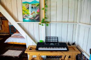 a keyboard sitting on a wooden table in a room at Santorini by Busybee Lake Cabins in Mwanza