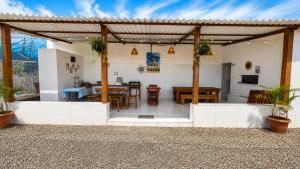 a patio with a table and chairs in a house at Sonho Nosso in Maragogi