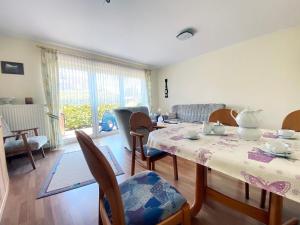 a dining room with a table and chairs and a living room at Ferienwohnung Marianne 26835 Neukamperfehn in Neukamperfehn