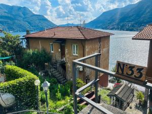 a house on the side of a body of water at Como Lake Paradise vicino a Nesso e Bellagio in Pognana Lario