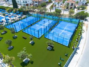 an overhead view of two tennis courts on a lawn at Sveltos Hotel in Larnaca