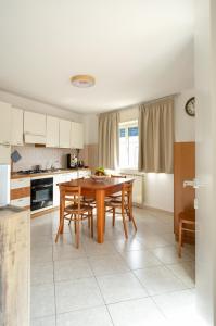 a kitchen with a wooden table and chairs in a room at Terrazza con vista in Nicosia