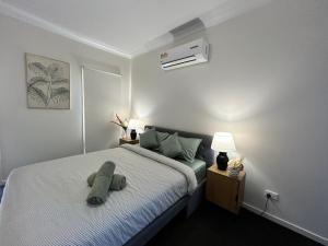 a bedroom with a bed with a pillow on it at Valley View 4BR home near Food trucks and Station in Melton South
