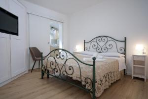 a bedroom with a bed and a chair and a television at Terrazza con vista in Nicosia