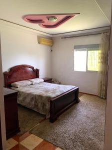 a bedroom with a bed and a ceiling at maison avec jardin in Cabo Negro