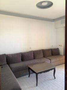 a living room with a couch and a coffee table at maison avec jardin in Cabo Negro
