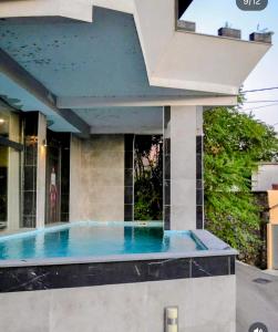 a house with a swimming pool in front of a building at Apart Mostar in Mostar