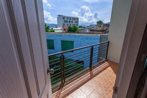 a balcony with a view of a building at JB Old Town Stay in Ban Lo Long