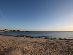 a sandy beach with the ocean in the background at St Abbs Cottage in Belford +3 photos