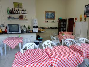 a restaurant with red and white checkered tables and chairs at Pousada Mirantes Do Sincorá in Mucugê +20 photos