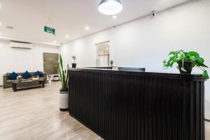 a bar in a living room with plants at RCC Hotels Elite Begumpet in Hyderabad