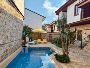 a swimming pool in a yard with a house at Sabah Homes in Antalya