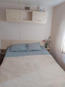 a bedroom with a large bed with a blue blanket at Sky house in Jūrmala